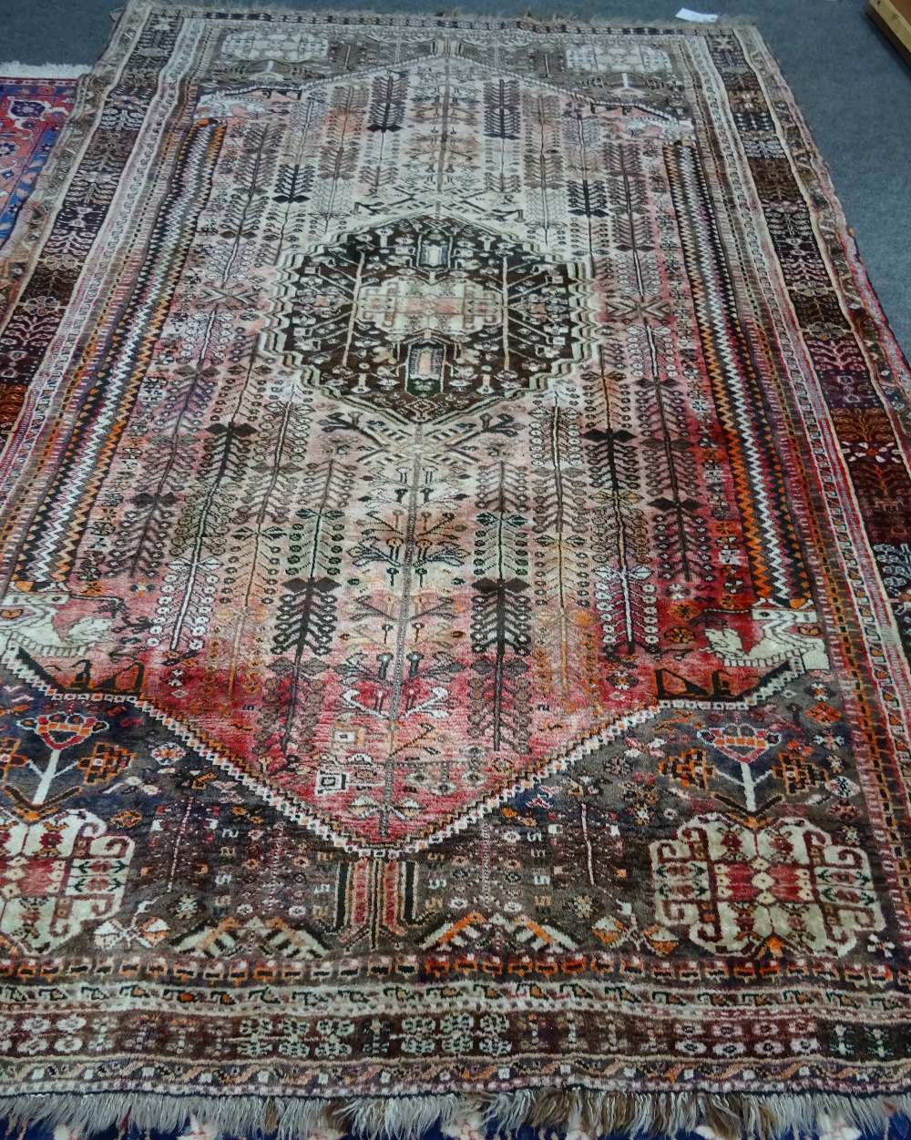 A Ghasghai Persepolis carpet, South Persian, the madder field with a brown medallion,