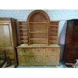 'TAN HOUSE DESIGNS', a modern satin birch arch top bookcase cabinet, on plinth base,
