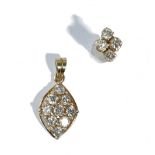 A gold and diamond nine stone pendant in a marquise shaped cluster design,