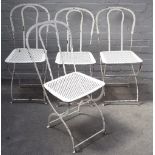 A set of four 20th century white painted wrought iron garden chairs, on 'X' frame bases,