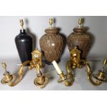 A pair of early 20th century brass two branch wall lights, 32cm wide, a modern ebonised lamp,
