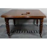 A Victorian mahogany extending dining table, on reeded tapering supports, with one extra leaf,