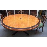 A large Regency style ebony-banded figured maple circular centre table,