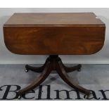 A 19th century mahogany flap side table on turned column and