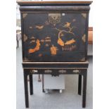 A George II Japanned cabinet on stand, the fall revealing a fitted interior,