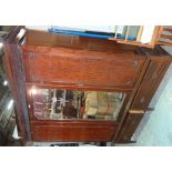 A late Edwardian mahogany triple wardrobe, the central mirrored door over two drawer plinth base,