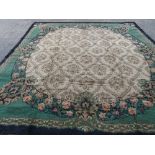A Donegal carpet, the fan roundel with a trellis, each section centred with a flowerhead,