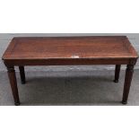 An 18th century style stained oak window seat, on tapering octagonal supports,