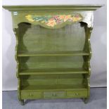 An early 20th century green painted three tier hanging plate rack, with three frieze drawers,