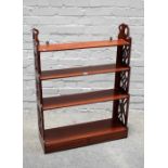 A George III style set of four tier mahogany shelves, with a pair of drawers and fret cut sides,