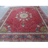 A Wilton carpet, machine made of Persian design, the red field with central medallion,