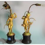 A pair of early 20th century gilt metal table lamps, formed as cherubs, 39cm high.