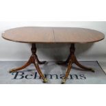 A George III style mahogany D-end dining table, one extra leaf, on three downswept supports,