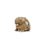 A Japanese ivory netsuke of a puppy, 19th/20th century, carved seated with inlaid eyes, signed, 3.