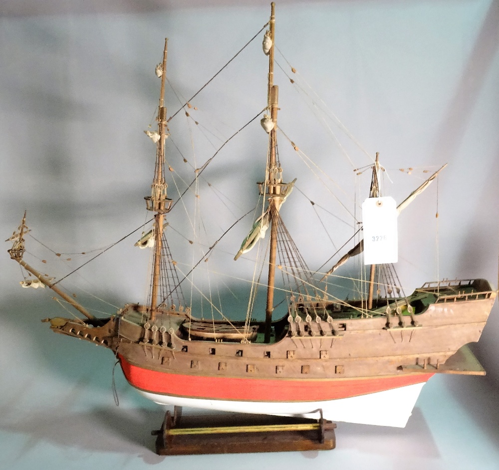 An early 20th century wooden model of a triple mast galleon, 97cm wide x 87cm high.