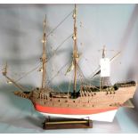 An early 20th century wooden model of a triple mast galleon, 97cm wide x 87cm high.