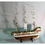 A modern wooden model of a triple mast galleon, 84cm wide x 80cm high.