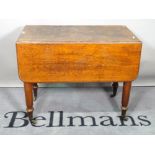 An early Victorian mahogany drop flap side table on turned supports, 90cm wide x 73cm high.