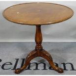 A George III and later mahogany tripod table, the dished circular top on ball and claw supports,