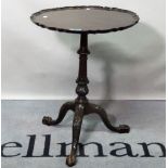 An 18th century style mahogany tripod table, with pie crust top over turned column supports,