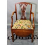 A late George III mahogany commode open armchair, on tapering square supports,