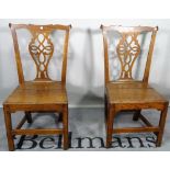 A pair of 18th century oak pierced splat back chairs, 49cm wide x 95cm high,