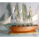 A modern wooden model of a triple mast galleon, 80cm wide x 78cm high.