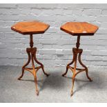 A pair of 18th century style walnut hexagonal topped occasional tables, on three hoof feet,
