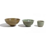 A Chinese celadon bowl, the interior incised with foliate scrolls beneath an olive green glaze,