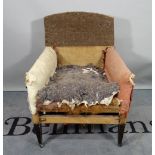 A 19th century beech framed low armchair, on tapering square supports.