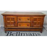 An 18th century style oak low sideboard, with two short drawers flanked by cupboards,