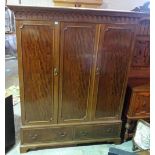 A Regency style mahogany triple wardrobe, with panelled moulded doors over single drawer base,