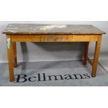 An early 20th century stained beech work table, with painted top on block supports,