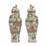 A pair of Canton famille-rose slender baluster vases and covers, 19th century,