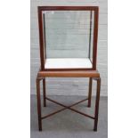 A 19th century free standing mahogany framed display cabinet on channelled block supports,