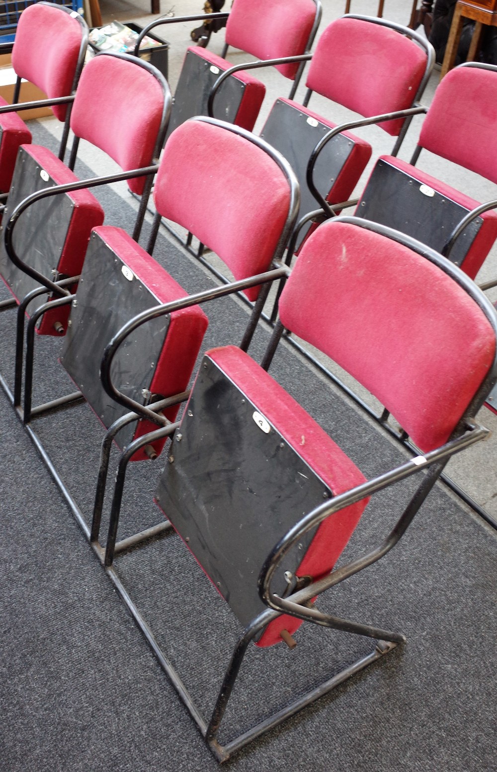 A bank of four red upholstered folding theatre seats, on black metal tubular frames, - Image 2 of 2