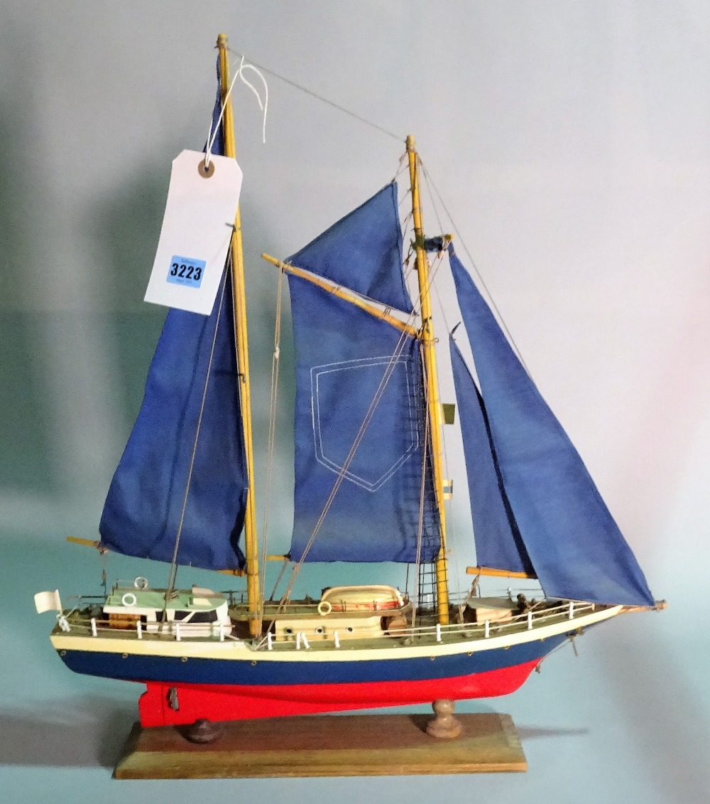 A modern wooden model of a sailing boat, 55cm wide x 61cm high.