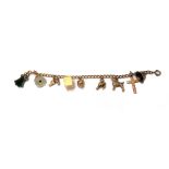 A gold curb link charm bracelet, on a boltring clasp, fitted with nine mostly 9ct gold charms,