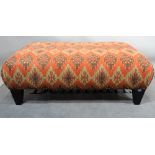A modern large rectangular footstool, on tapering square supports, 140cm wide x 48cm high.