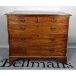 A late George III mahogany chest, of two short and three long graduated drawers, on bracket feet,