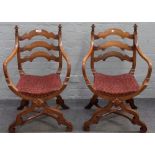 A pair of 19th century oak 'X' framed openarm side chairs, 55cm wide x 88cm high.