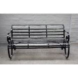 A 19th century black painted strap iron garden bench, 153cm wide x 78cm high.