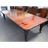 A late Victorian mahogany extending dining table, the moulded edge top with two extra leaves,