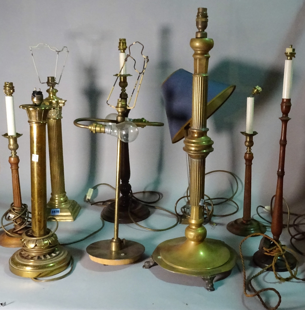 A group of eight 19th century and later table lamps, including brass, wooden and glass examples,