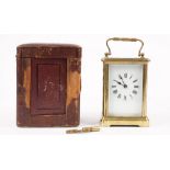 An early 20th century brass cased carriage clock with enamel dial,