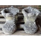 A pair of modern reconstituted stone planters, formed as boots, each 45cm wide x 26cm high.