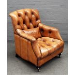 A 20th century brown leather upholstered easy armchair, on turned supports, 80cm wide x 96cm high.