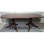 WARING & GILLOWS; a Regency style mahogany D-end extending dining table, on six downswept supports,