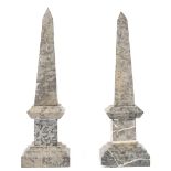 A pair of modern grey marble obelisks, of stepped square form, (a.f.), 70cm high.