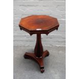 A Regency rosewood octagonal top centre table, on baluster column and three scroll feet,